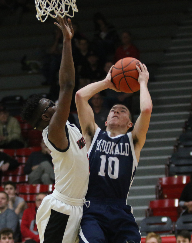 McDonald's Josh Celli (10) goes up for a shot while being defended by Kevin Traylor (3) of Struthers during the second half of Tuesday nights matchup at Struthers Field House.  Dustin Livesay  |  The Vindicator  2/20/18 Struthers