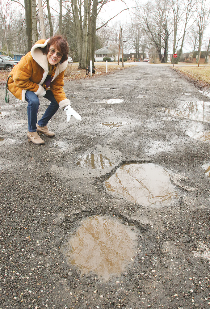 Liberty Township Trustee Jodi Stoyak points out the deteriorating condition of Trumbull Avenue near Northgate Drive. Trustees are contemplating a tax levy for road improvements this Fall. 