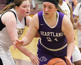 William D Lewis The Vindicator  Liberty's Melanie Bardel(33) defends as )  Heartland's Jana Croyts(24) dribbles during 2-21-18 action at Liberty.