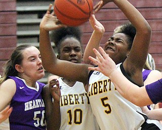 William D Lewis The Vindicator  Liberty's Delia Watson(5) shoots around Heartland's Megan Johnson (50) during 2-21-18 action at Liberty. Liberty's Sierra Williams(10) is at center.