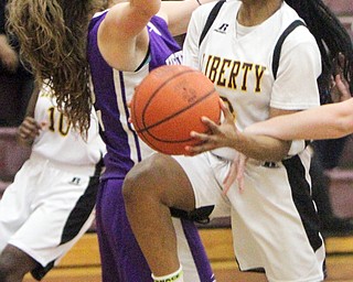 William D Lewis The Vindicator  Liberty's China Tate(3) drives around Heartland's Sydney Ogden(12) during 2-21-18 action at Liberty.