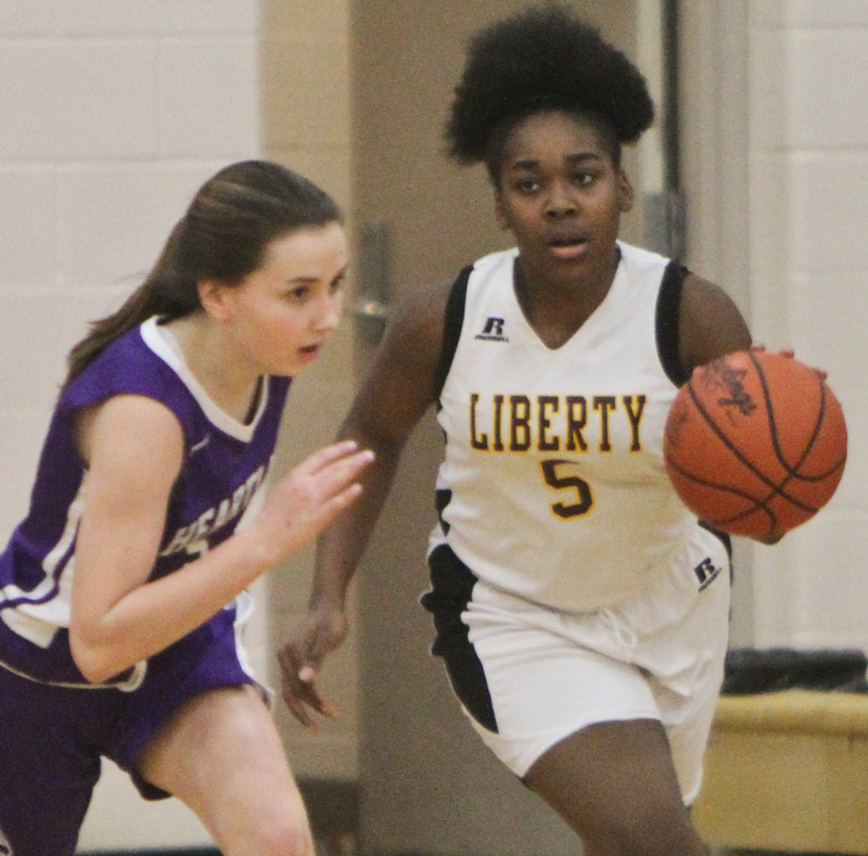 William D Lewis The Vindicator  Liberty's Delia Watson(5) drives around Heartland's Jeanna Morgan (5) during 2-21-18 action at Liberty.