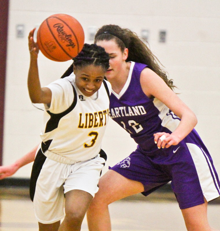 William D Lewis The Vindicator  Liberty's DChina Tate(3)) drives around Heartland's Sydney Ogden(12) during 2-21-18 action at Liberty.