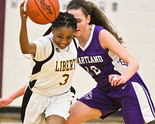 William D Lewis The Vindicator  Liberty's DChina Tate(3)) drives around Heartland's Sydney Ogden(12) during 2-21-18 action at Liberty.