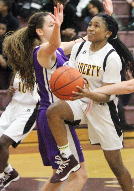 William D Lewis The Vindicator  Liberty's China Tate(3) drives around Heartland's Sydney Ogden(12) during 2-21-18 action at Liberty.