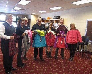 Neighbors | Zack Shively.Top Flight Financial donated 51 coats to the Boardman elementary schools. They brought the coats to Stadium Drive Elementary on Jan. 4, where they will distributed among students in all four elementary schools. Pictured, from left, are Jimmy Ament, Mary Jo Kollat, Mary Ann Pollack, Ryan Cuffle and Ciera Parry of Top Flight Financial and Michael Zoccali and Jennifer Carey of Stadium Drive Elementary.
