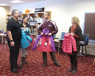 Neighbors | Zack Shively.Branch manager Ryan Cuffle and other representatives from Top Flight Financial met with principal Michael Zoccali and school counselor Jen Carey of Stadium Drive Elementary to donate coats for children. The coats will go to students in need of winter coats to help the families throughout the elementary schools.