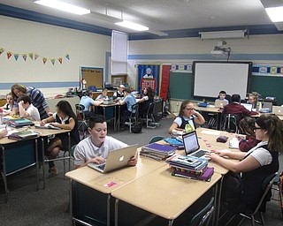 Neighbors | Zack Shively.St. Christine students returned to class on Jan. 25. Some classrooms had been moved or adjusted while the school finished repairs. Pictured, students had class in Room A, a former meeting room that have the meeting equipment removed and classroom furniture placed.