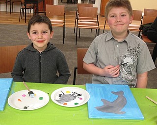 Neighbors | Zack Shively.Children from grades kindergarten to fourth painted a dolphin at the Poland library. Pictured, Nathan and Joseph Torres used grey paint to make their dolphins.