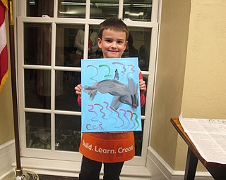 Neighbors | Zack Shively.Once the children were done with their paintings, they used a blow dryer to dry the paint quickly. Pictured, Christian Steed finished his dolphin painting.