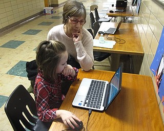 Neighbors | Zack Shively.Market Street Elementary had two groups of families go to different classrooms for different stations. The families of the higher grade students had test preparation, and the lower grade students had a story time. Both groups had technology, vocabulary, reading and writing stations. Pictured, kindergarten student Fiona Maloney showed Mary Gould her skills on the school's Chromebooks.