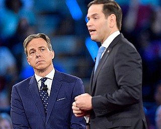 CNN's Jake Tapper listens to Republican Sen. Marco Rubio during a CNN town hall meeting, Wednesday, Feb. 21, 2018, in Sunrise, Fla. Rubio is being challenged by angry students, teachers and parents who are demanding stronger gun-control measures after a school shooting that killed more than a dozen people at a Florida high school. 