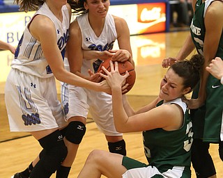 Poland guard Sarah Bury (2)(center) and Poland forward Maggie Sebest (13) hold onto the ball as Ursuline's Lindsay Bell (35) falls to the grounf in the fourth quarter of an Division II sectional final high school basketball game, Thursday, Feb. 22, 2018, in Poland. Poland won 50-49...(Nikos Frazier | The Vindicator)
