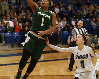 Ursuline's Dayshonette Harris (1) goes up for a layup past Poland guard Bella Gajdos (0) in overtime of an Division II sectional final high school basketball game, Thursday, Feb. 22, 2018, in Poland. Poland won 50-49...(Nikos Frazier | The Vindicator)