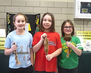 Neighbors | Zack Shively.Holy Family Church does a number of service projects sponsored by the Home and School Association during Catholic Schools Week. This year, the three students pictured will donate their hair to Children with Hair Loss, a nonprofit that delivers hair to children in need. The students are, from left, Hannah LaPlante, Giuliana Ricchiuti and Audrina Jablonski.