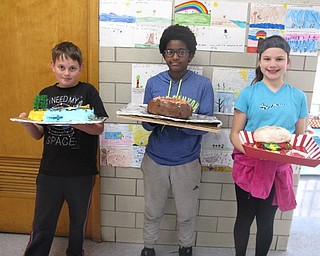 Neighbors | Zack Shively.Students at Holy Family School made cakes for a cake walk the school had on Feb. 3. The cakes were displayed in the school all week. The students decoraded around a box cake for their designs. Pictured are, from left, Evan Brockway, Tiji Rogers and Maria Wilson.