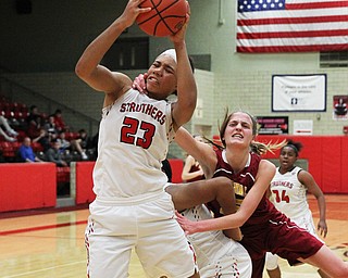Trinity McDowell (23) of Struthers gets pulled down after making a rebound by Mooney's Lauren Frommelt (15) during Thursday nights tournament game at the Struthers field house.  Dustin Livesay  |  The Vindicator  2/22/18 Struthers.