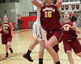 Mooney's Lauren Frommelt (15) gets fouled by Michelle Buser (22) of Struthers while going up for a layup during the second half of Thursday nights tournament game at the Struthers field house.  Dustin Livesay  |  The Vindicator  2/22/18 Struthers.