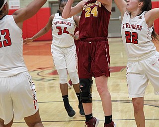 Kelly Williams (24) of Mooney puts up a jump shot while being defended by Michelle Buser (22) and Trinity McDowell (23) if Struthers during the second half of Thursday nights tournament game at the Struthers field house.  Dustin Livesay  |  The Vindicator  2/22/18 Struthers.