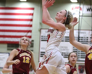 Alexis Bury (13) of Struthers goes up for a layup while being defended by Mooney's Caitlin Perry (44) during the first half of Thursday nights tournament game at the Struthers field house.  Dustin Livesay  |  The Vindicator  2/22/18 Struthers.