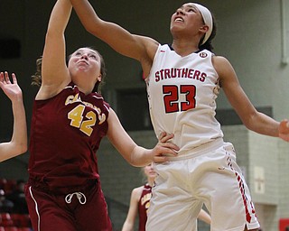 Trinity McDowell (23) of Struthers fights for a rebound with Mooney's Conchetta Rinaldi (42) during Thursday nights tournament game at the Struthers field house.  Dustin Livesay  |  The Vindicator  2/22/18 Struthers.