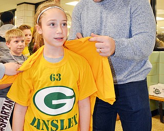 Scott Williams - The Vindicator - 2009 Boardman graduate and current Green Bay Packers center Corey Linsley signs a teeshirt for Ella Dota, an 11 year old from Boardman.  Linsley was a featured guest at the Boardman vs Austintown Fitch game on Friday February 23, 2018.