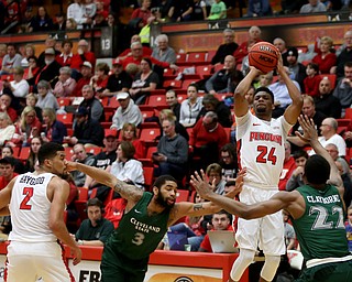 Youngstown State guard Cameron Morse (24) goes up for three as Cleveland State forward Evan Clayborne (22) and Cleveland State guard Dontel Highsmith (3) scramble to attempt to block his shot during the first half of a NCAA Horizon League college basketball game, Saturday, Feb. 24, 2018, in Youngstown...(Nikos Frazier | The Vindicator)