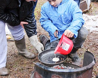 Jacob Wolfe (right) and Owen Waller of Troop 9046 of Boardman make pancakes on an opeb fire during the Klondike Gold Rush at Camp Stambaugh on Saturday morning.  Dustin Livesay  |   The Vindicator  2/24/18  Camp Stambaugh