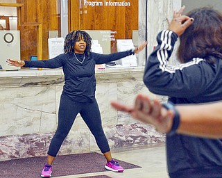 Scott Williams - The Vindicator - Zumba instructor Kelley Frazier from Mercy Health gets attendees of the Delta Sigma Theta Sorority Health Symposium moving at the Youngstown Metropolitan Housing Authority's Amedia Plaza on Saturday February 24, 2018.