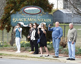 People line the street to pay respects as the hearse carrying the body of Rev. Billy Graham travels through Black Mountain, N.C., Saturday, Feb. 24, 2018. The procession is part of more than a week of mourning that culminates with his burial next week at his library in Charlotte.  (AP Photo/Kathy Kmonicek, Pool)