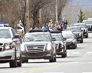 Mourners line Hwy 70 through Black Mountain, N.C. as the motorcade carrying Rev. Billy Graham passes by, on Saturday, Feb. 24, 2018.  It was a chance for residents in some of Grahamâ€™s favorite places to pay tribute. He often shopped or caught trains in Black Mountain.  The procession is part of more than a week of mourning that culminates with his burial next week at his library in Charlotte.   (John D. Simmons/The Charlotte Observer via AP)