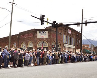 Mourners line Hwy 70 through Black Mountain, N.C. as the motorcade carrying  Rev. Billy Graham passes by, on Saturday, Feb. 24, 2018.  It was a chance for residents in some of Grahamâ€™s favorite places to pay tribute. He often shopped or caught trains in Black Mountain.  The procession is part of more than a week of mourning that culminates with his burial next week at his library in Charlotte.   (John D. Simmons/The Charlotte Observer via AP)