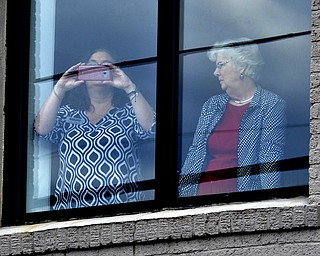 Mourners view the motorcade carrying Rev. Billy Graham through a window to in Black Mountain, N.C.,  on Saturday, Feb. 24, 2018. Lyons traveled from Muldoon, Texas.  It was a chance for residents in some of Grahamâ€™s favorite places to pay tribute. He often shopped or caught trains in Black Mountain.  The procession is part of more than a week of mourning that culminates with his burial next week at his library in Charlotte.   (John D. Simmons/The Charlotte Observer via AP)