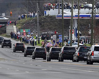 People line route 321 in Gastonia, N.C. to pay their respect to the late Billy Graham as the motorcade carrying his body approaches the I-85 junction to travel toward Charlotte Saturday afternoon, Feb. 24, 2018. (Mike Hensdill/The Gaston Gazette via AP)