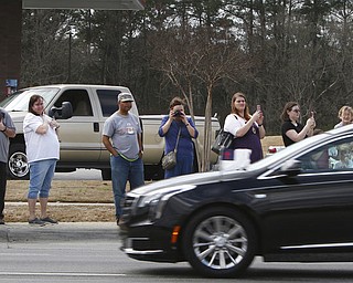 People line route 321 in Gastonia, N.C. to pay their respect to the late Billy Graham as the motorcade carrying his body approaches the I-85 junction to travel toward Charlotte Saturday afternoon, Feb. 24, 2018. (Mike Hensdill/The Gaston Gazette via AP)