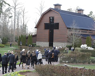 Pall bearers carry the casket carrying the body of Billy Graham as family member follow behind to the Billy Graham Library in Charlotte, N.C., Saturday, Feb. 24, 2018. Graham's body was brought to his hometown of Charlotte on Saturday, Feb. 24, as part of a procession expected to draw crowds of well-wishers. (AP Photo/Chuck Burton)