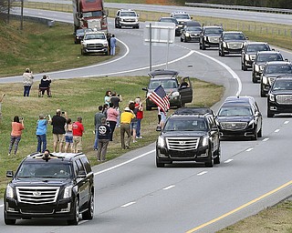 The Billy Graham procession drives south on U.S. 321 near Dallas. N.C. as it passes through Gaston County on it's way to Billy Graham Library in Charlotte, N.C. Saturday Feb. 24, 2018. (John Clark/The Gaston Gazette via AP)