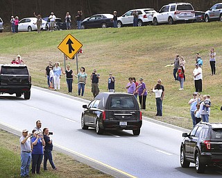 The Billy Graham procession drives south on U.S. 321 near Dallas. N.C. as it passes through Gaston County on it's way to Billy Graham Library in Charlotte, N.C. Saturday Feb. 24, 2018. (John Clark/The Gaston Gazette via AP)