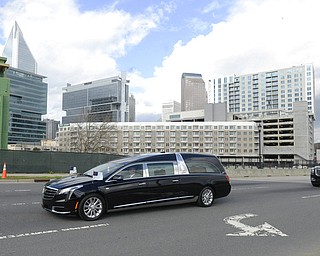 The motorcade carrying the body of the late Rev. Billy Graham winds its way through uptown Charlotte, N.C. on the way to the Billy Graham Library on Saturday, Feb. 24, 2018. (David T. Foster III/The Charlotte Observer via AP)