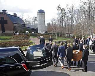 Pall bearers carry the casket with the body of Billy Graham past family members to the Billy Graham Library in Charlotte, N.C., Saturday, Feb. 24, 2018. Graham's body was brought to his hometown of Charlotte on Saturday, Feb. 24, as part of a procession expected to draw crowds of well-wishers. (AP Photo/Nell Redmond)