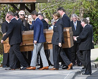 Pallbearers carry the casket with the body of Billy Graham past family members as it arrives at the Billy Graham Library in Charlotte, N.C., Saturday, Feb. 24, 2018. (AP Photo/Kathy Kmonicek, Pool)