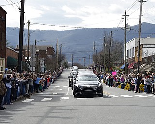 People line the street to pay respects as the hearse carrying the body of Rev. Billy Graham travels through Black Mountain, N.C., Saturday, Feb. 24, 2018. (AP Photo/Kathy Kmonicek, Pool)