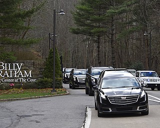 The hearse carrying the body of Billy Graham leaves the Billy Graham Training Center in Asheville, N.C., Saturday, Feb. 24, 2018. Graham's body was brought to his hometown of Charlotte on Saturday, Feb. 24, as part of a procession expected to draw crowds of well-wishers. (AP Photo/Kathy Kmonicek, Pool)