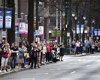 People line the street to watch the casket carrying the body of Billy Graham travel through Charlotte, N.C., Saturday, Feb. 24, 2018. Graham's body was brought to his hometown of Charlotte on Saturday, Feb. 24, as part of a procession expected to draw crowds of well-wishers. (AP Photo/Kathy Kmonicek, Pool)