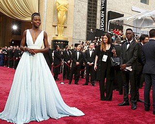 FILE - In this March 2, 2014 file photo, Lupita Nyong'o arrives at the Oscars in Los Angeles. Nyong'o, wearing a light blue Prada gown, won the Oscar for best supporting actress for her role in "12 Years a Slave." (Photo by Matt Sayles/Invision/AP, File)