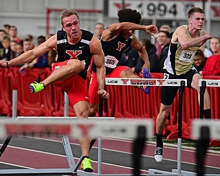YOUNGSTOWN, OHIO - FEBRUARY 25, 2018: Youngstown State's Chad Zallow clears a hurdle while running to the finish line against Youngstown State's Myron Anderson and Oakland's Zachary Stadnika during the Horizon League Indoor track Championship meet. DAVID DERMER | THE VINDICATOR