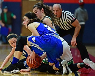 AUSTINTOWN, OHIO - FEBRUARY 26, 2018: West Branches's Peyton Alazaus and Poland's Jackie Grisdale wrestle for the loose ball near the sideline during the second half of their OHSAA Division 2 district tournament game on Monday night at Fitch High School. West Branch won 47-25. DAVID DERMER | THE VINDICATOR