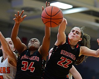 AUSTINTOWN, OHIO - FEBRUARY 26, 2018: Struthers' Michelle Buser, right, Keasia Chism and Howland's Mackenzie Maze fight for a rebound during the second half of their OHSAA district tournament game at Fitch High School. Howland won 35-24. DAVID DERMER | THE VINDICATOR