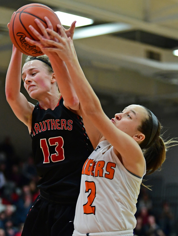 AUSTINTOWN, OHIO - FEBRUARY 26, 2018: Struthers' Alexis Bury, left, and Howland's Maria Dellimuti fight for a rebound during the second half of their OHSAA district tournament game at Fitch High School. Howland won 35-24. DAVID DERMER | THE VINDICATOR