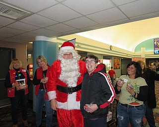 The Home Life Committee of the GFWC Ohio Warren Junior Women’s League treated more than 350 moviegoers from the Fairhaven Foundation to a morning at the movies in December. The league has helped to underwrite the event for the past 11 years. Santa and his elves greeted those attending with a popcorn treat, hugs and holiday wishes. Above, from left, are Esther Gartland, Diane Taylor, Santa (Scott Taylor), Justin Valenti and Jonnah Hetzel, WJWL president.
